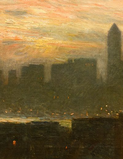 A city skyline at sunset obscured by mist in the background with several smaller buildings visible more clearly in the foreground. Several windows in the buildings show their lights on as night approaches.