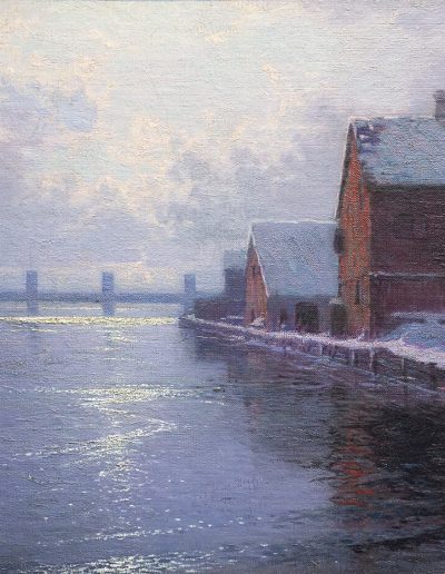 Two snow covered buildings next to a body of water. Wooden docks are seen in the background.