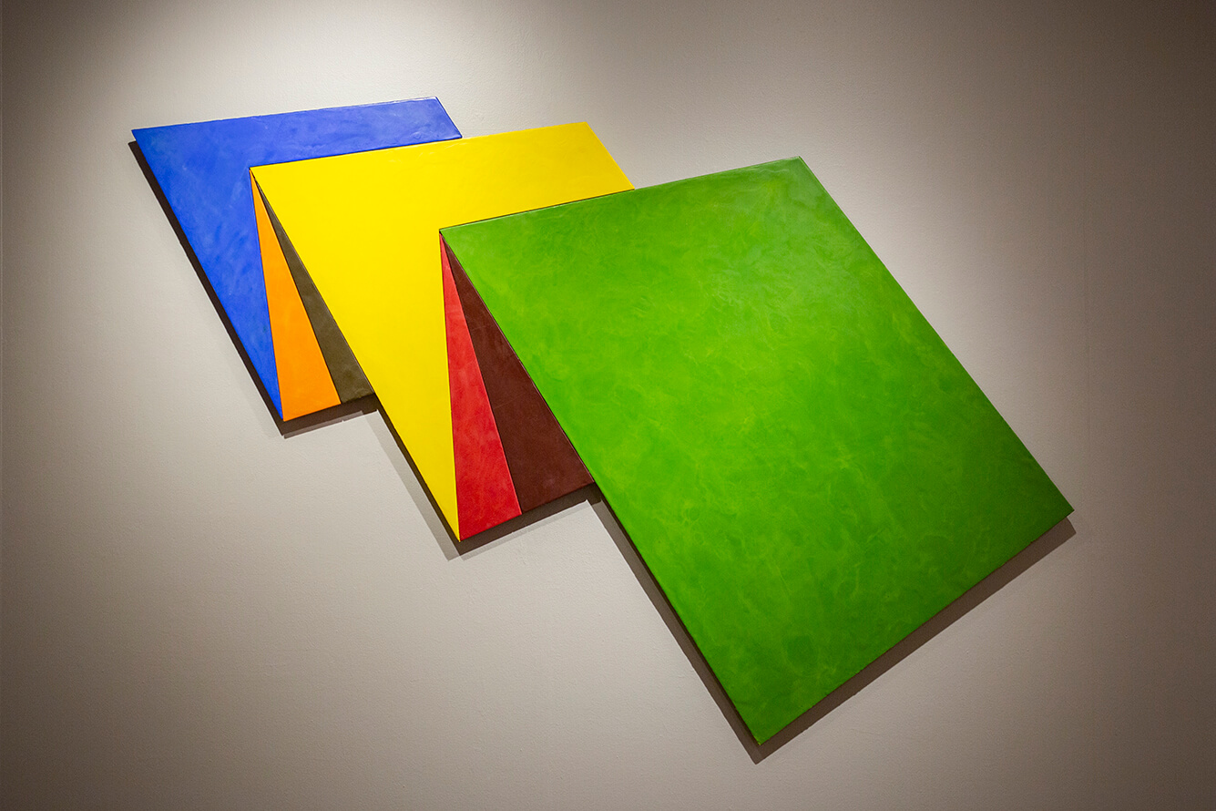 Several square shapes stacked on top of each other. The squares are blue, yellow, red, and green.